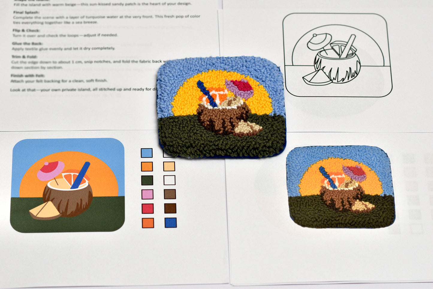 Embroidery pattern book with a completed design of a beach scene with a coconut drink.