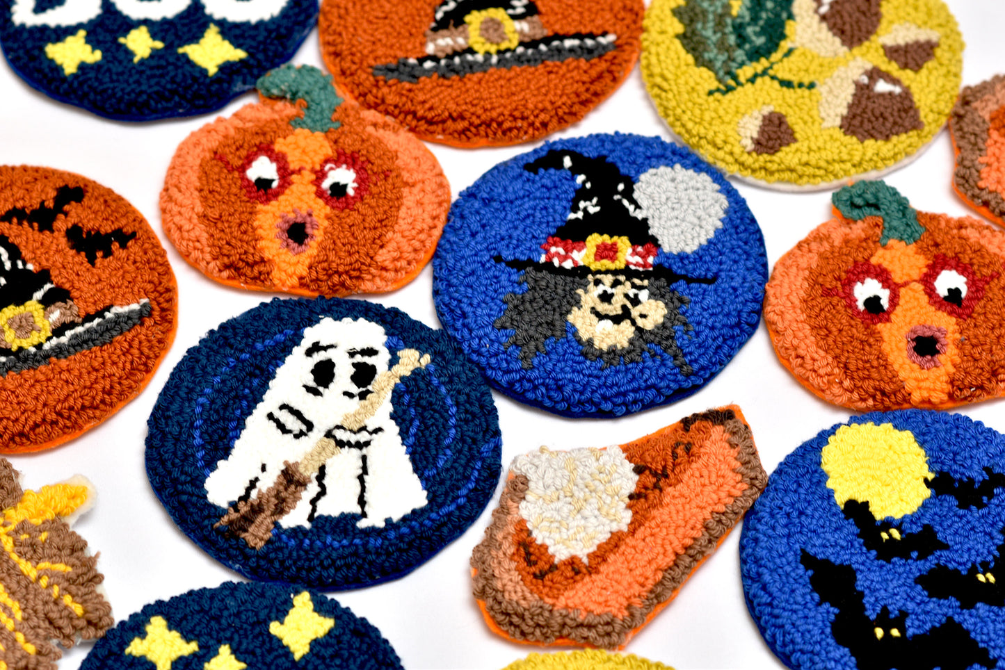 Collection of Halloween-themed embroidered punch needle coasters on a white background