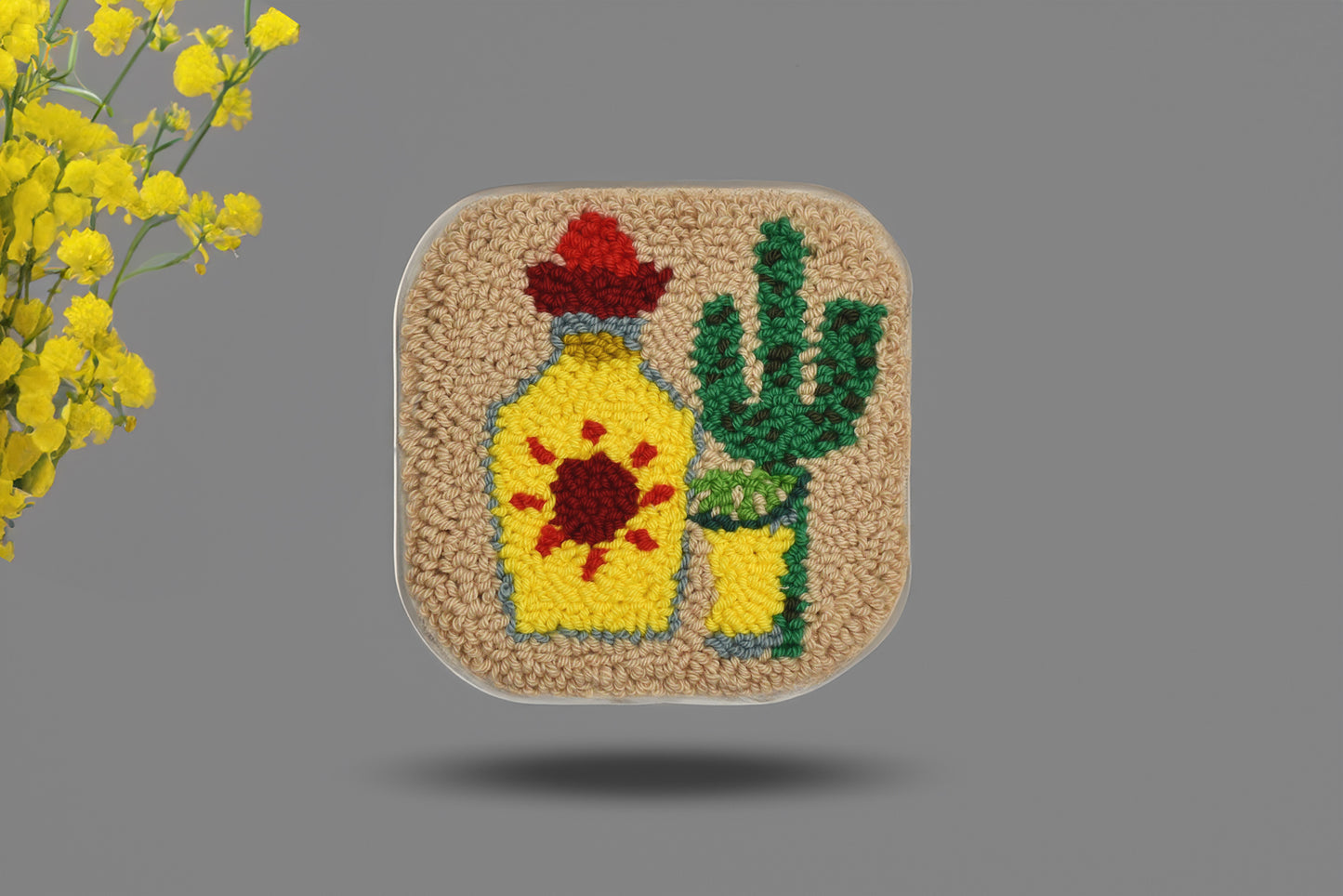 Embroidered patch with a bottle of tequila and cactus on a gray background