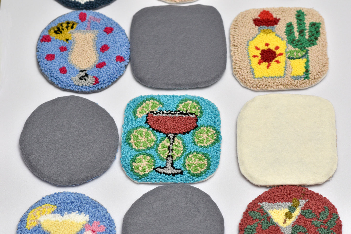Collection of colorful coasters with various designs on a white background