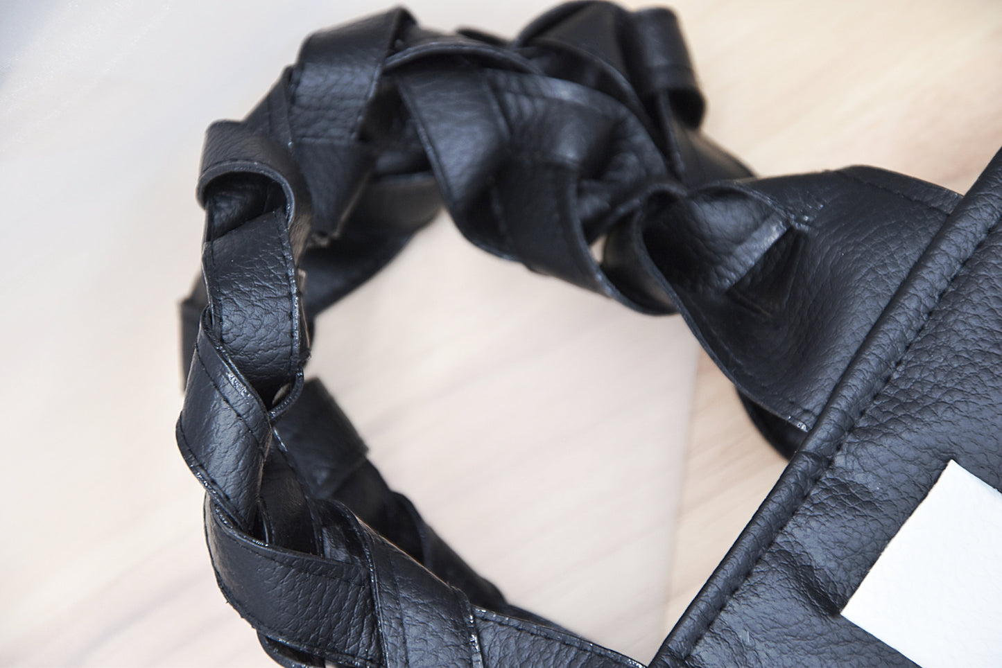 Mini faux leather hand-woven handbag in black and white with braid handle