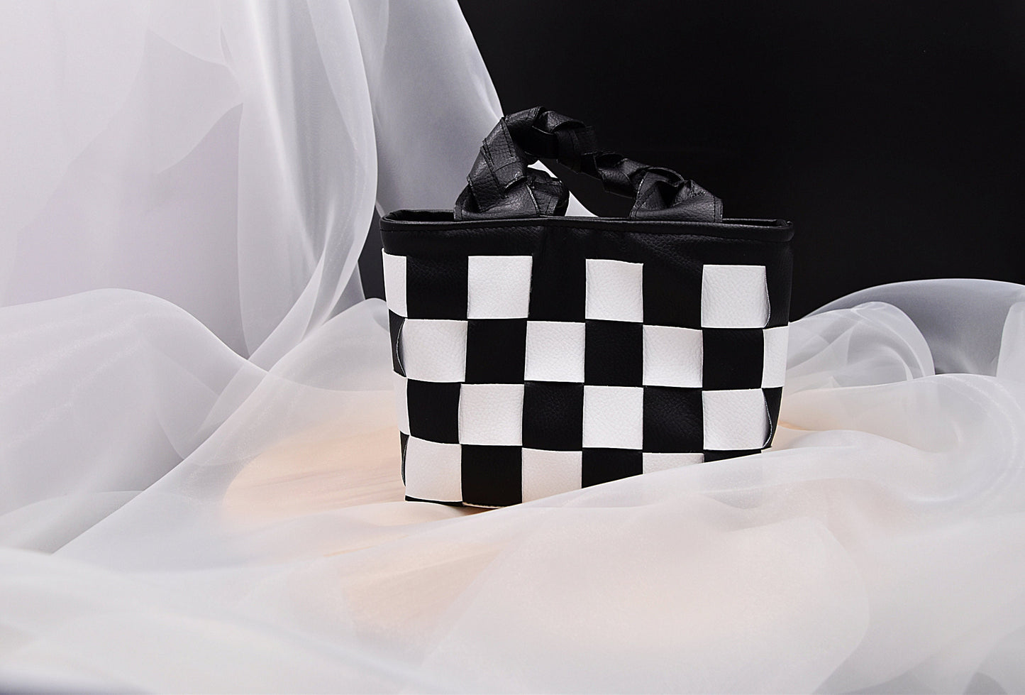 Mini faux leather hand-woven handbag in black and white with braid handle