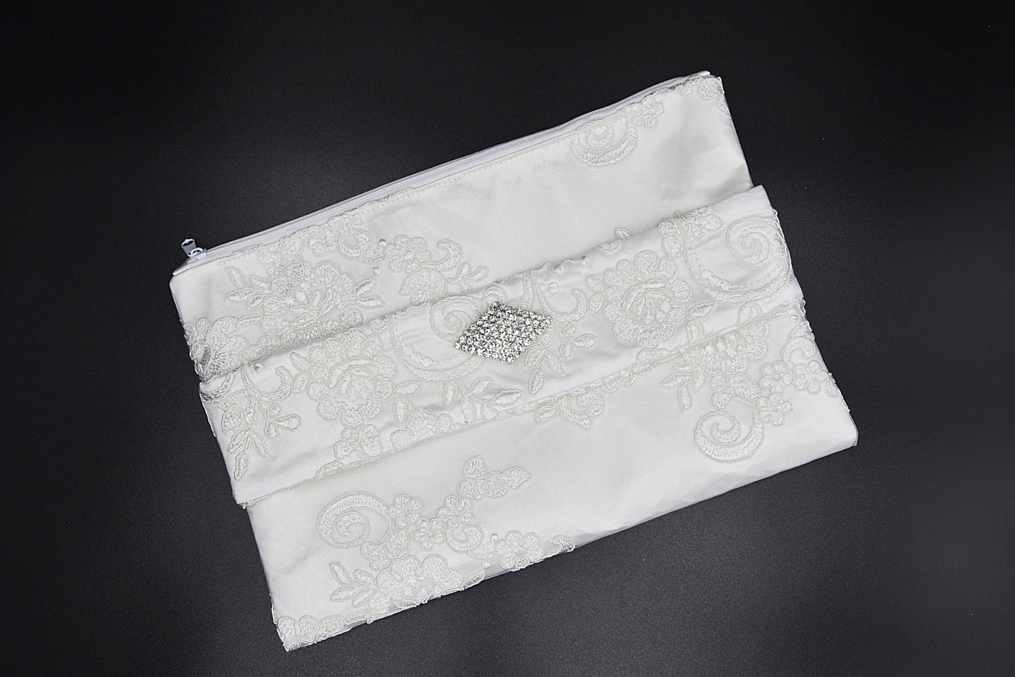 Bridal clutch bag in white lace with rhinestone brooch