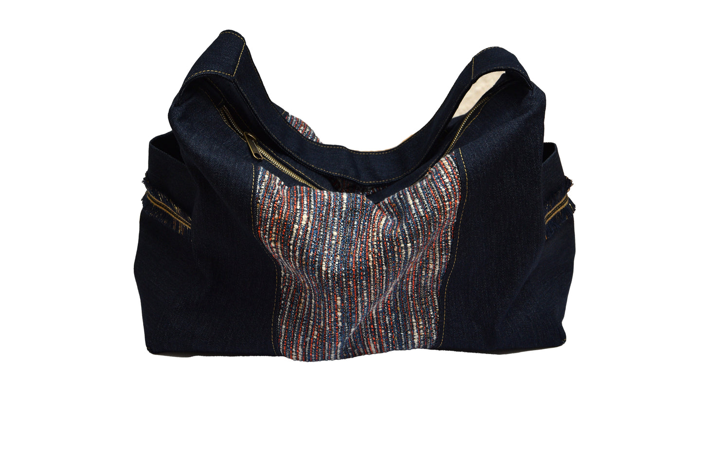 Black and denim handbag with a patterned patch on a white background