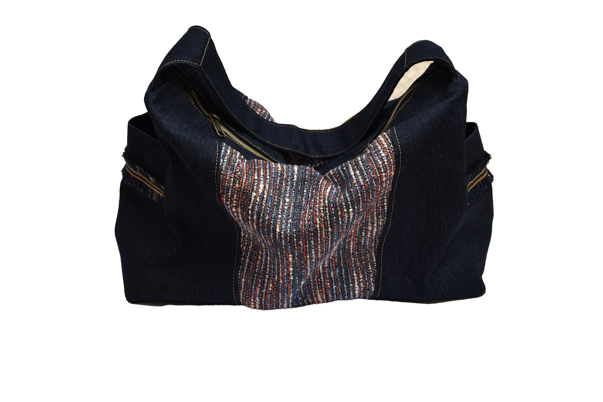 Black and denim handbag with a patterned patch on a white background