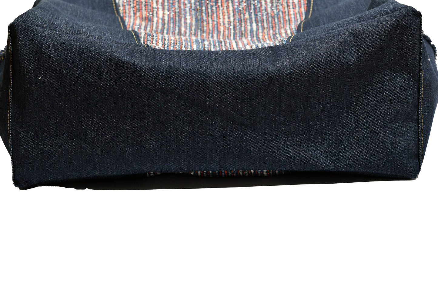 Folded dark blue fabric with a circular pattern on a white background