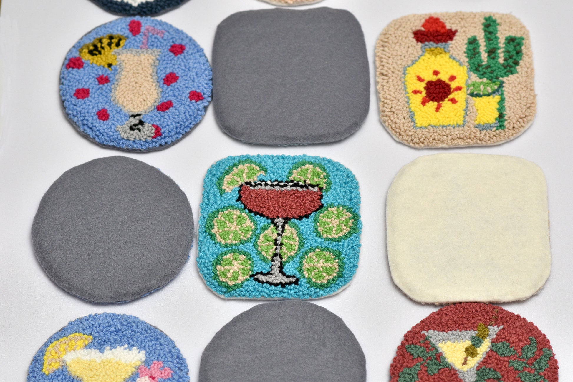 Collection of colorful coasters with various designs on a white background