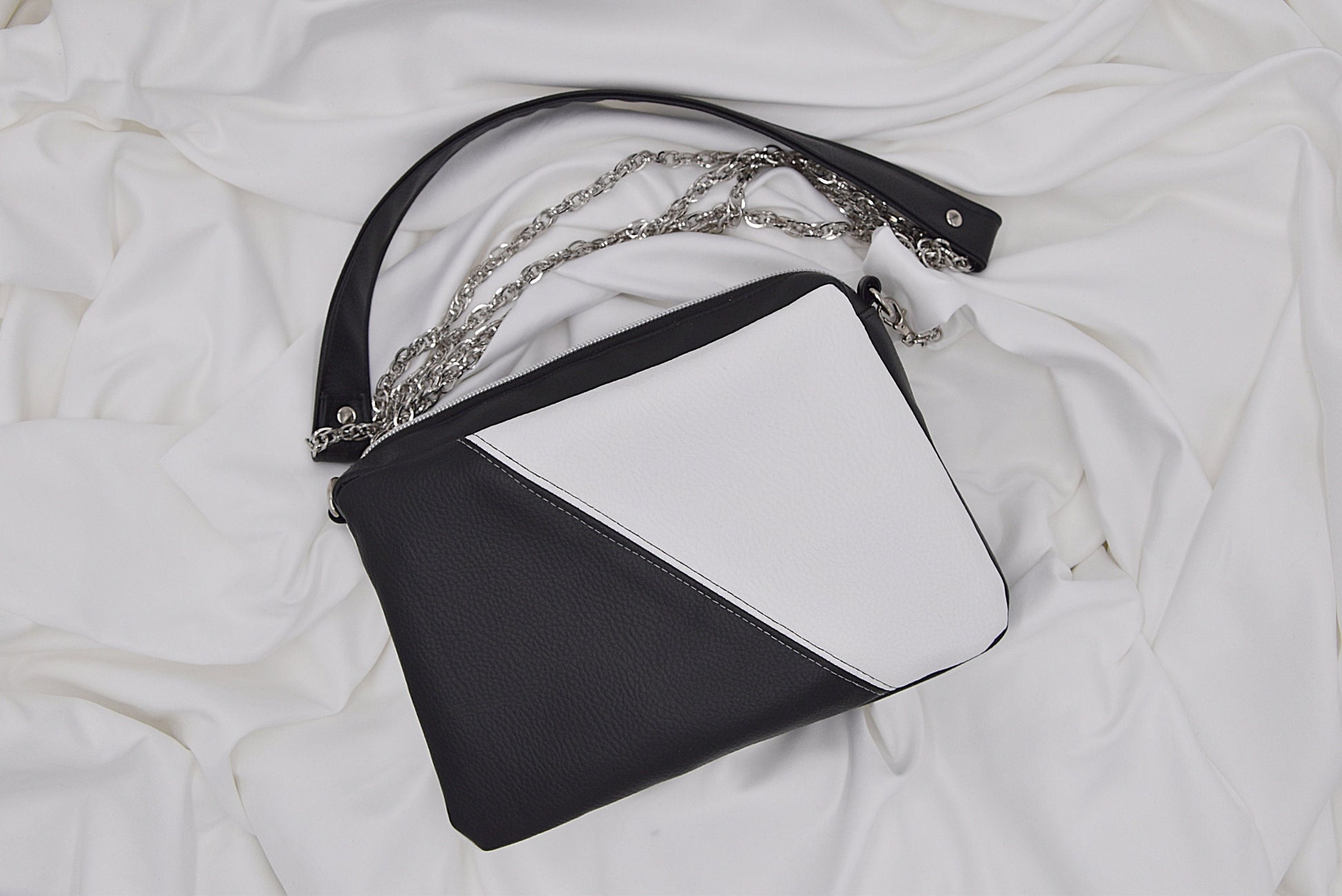 Black and white faux leather shoulder bag with chain and leather strap