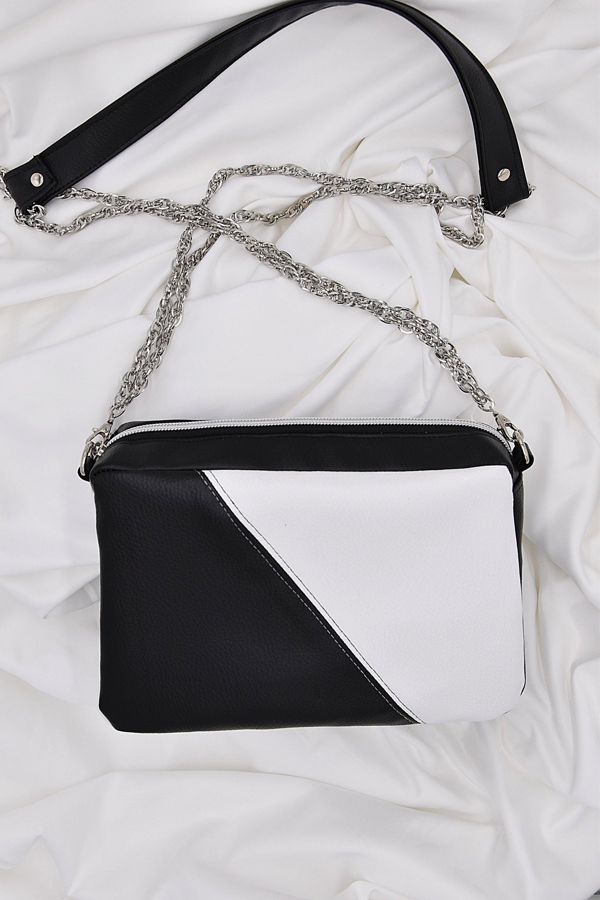 Black and white faux leather shoulder bag with chain and leather strap