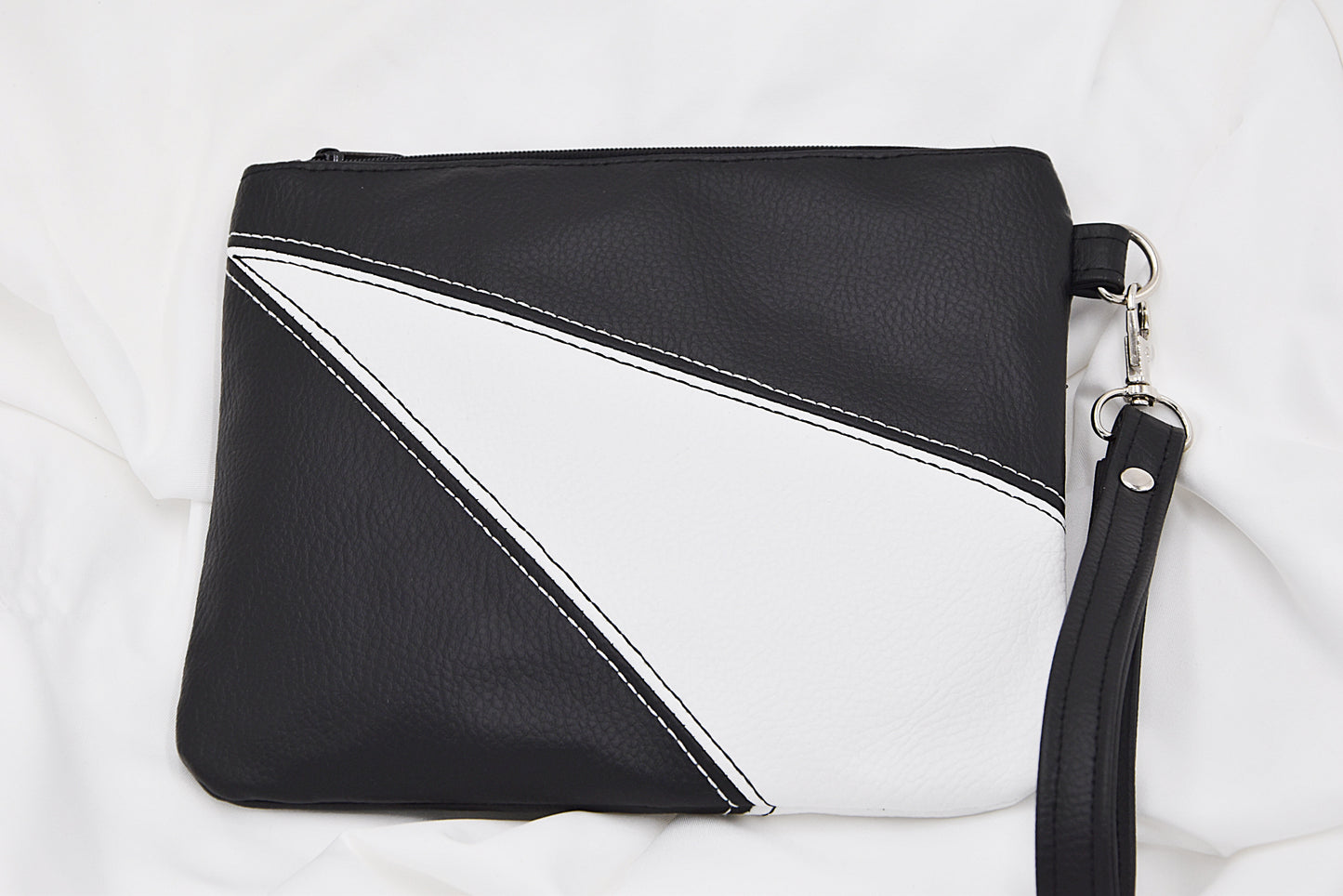 Black and white faux leather wristlet bag